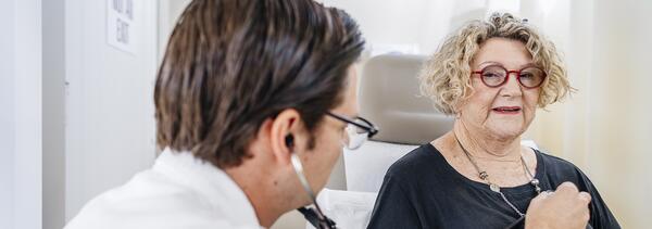 woman having her heart listened to